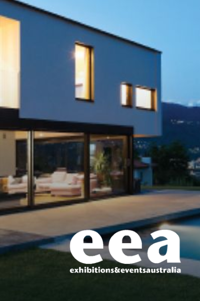 Modern home with large windows, grassy lawn, and 