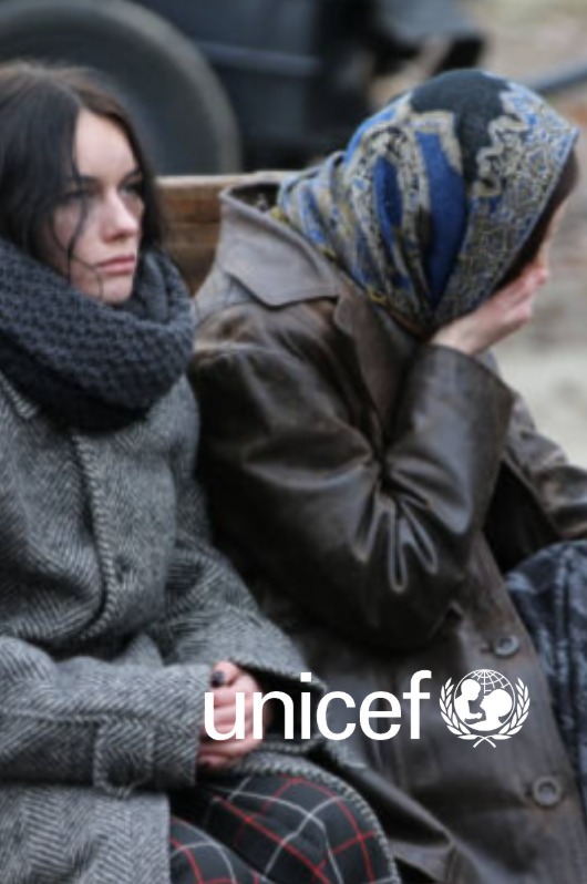 Two women sit on a bench, one in a scarf, one wearing a headscarf, looking distressed. UNICEF logo.