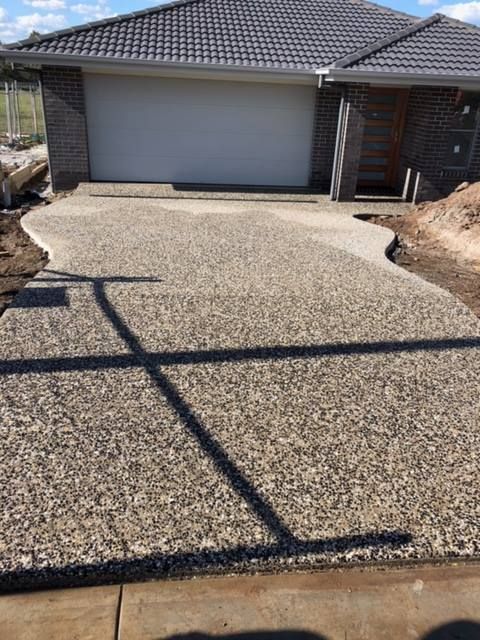 Exposed Aggregate Concrete Driveway Leading to a House — Heritage Concrete In Uralla, NSW