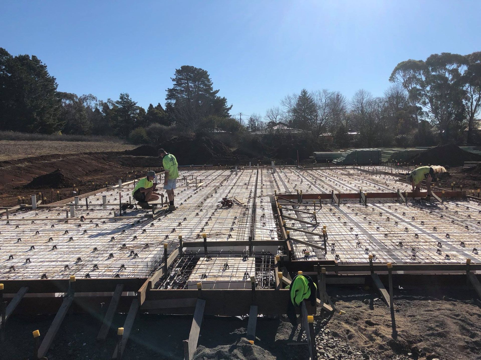 Construction Workers on a Concrete Foundation, Placing Rebar and Forms — Heritage Concrete In Uralla, NSW