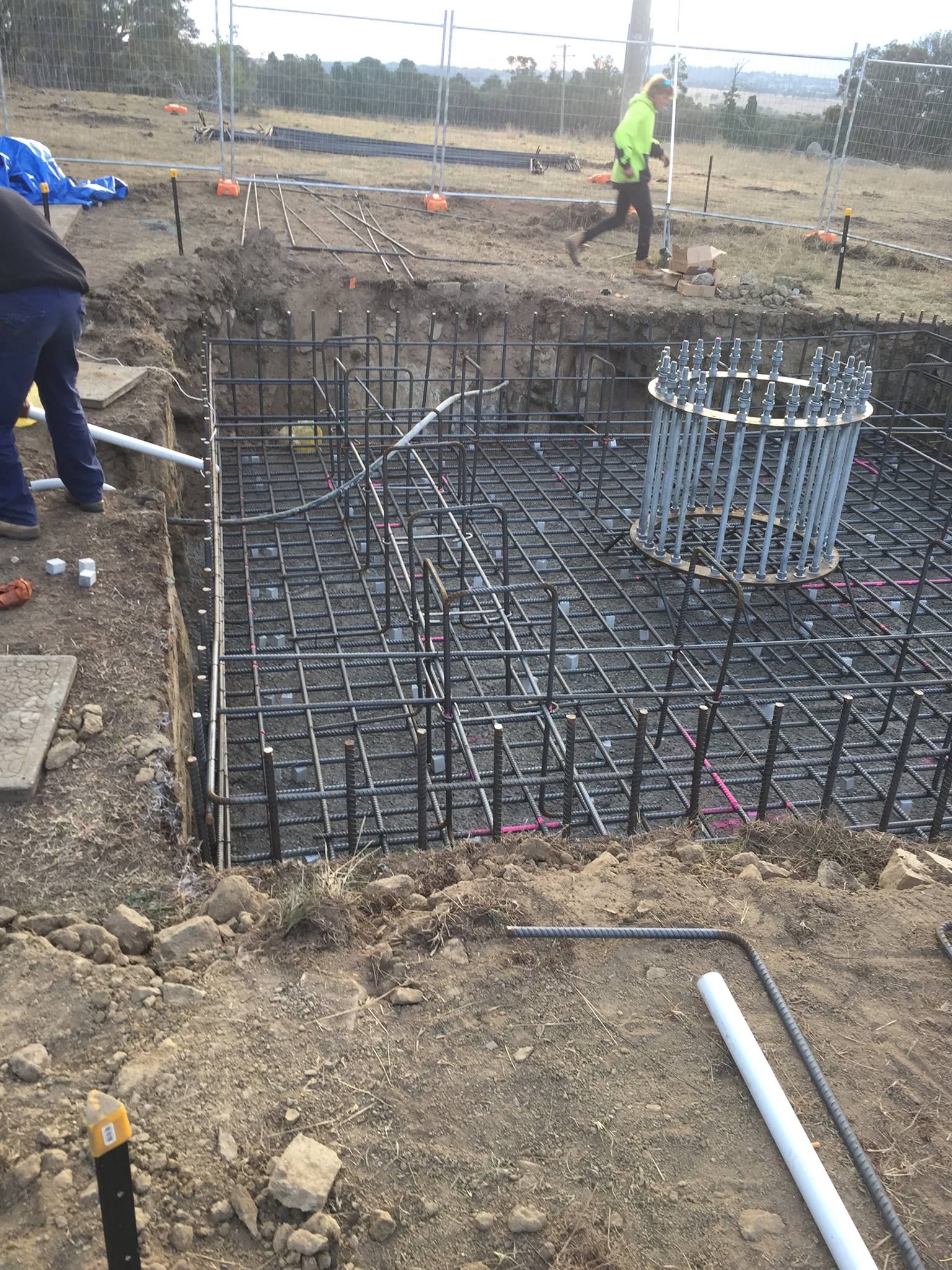 Construction Site With Rebar Framework in a Foundation Pit — Heritage Concrete In Uralla, NSW