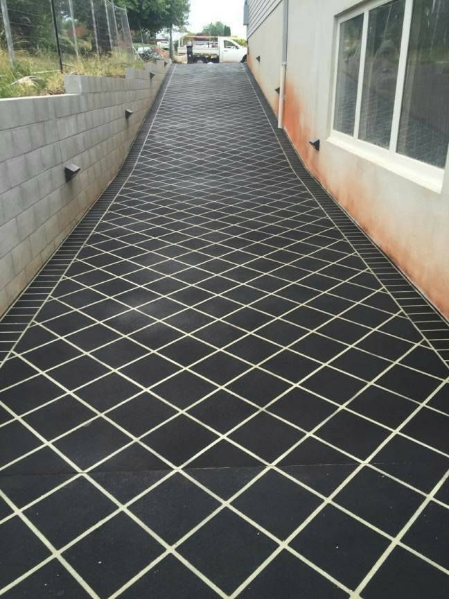 Black Diamond-patterned Driveway Slopes Upward Toward Distant White Vehicle — Heritage Concrete In Uralla, NSW