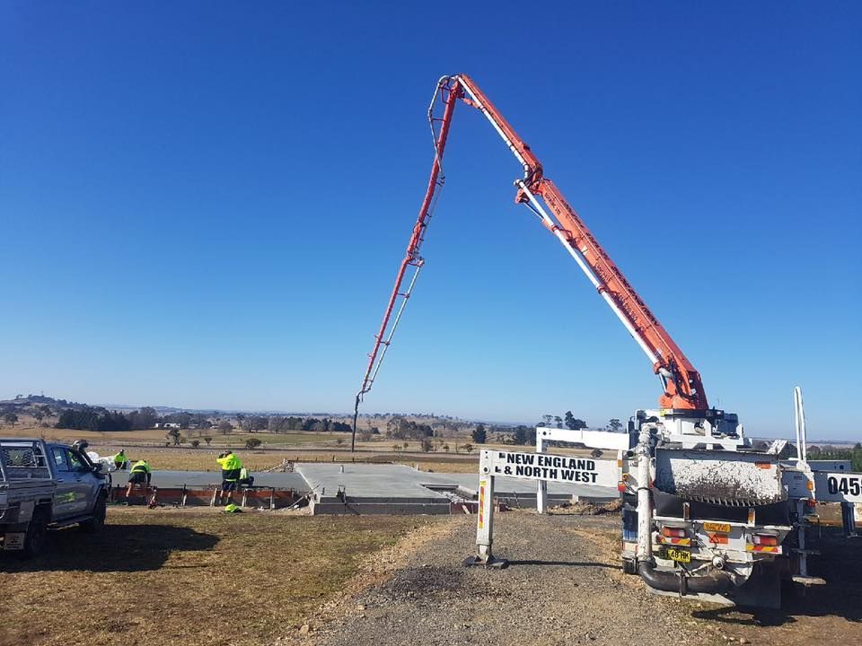 Concrete Pump Truck Pouring Concrete Onto a Foundation — Heritage Concrete In Uralla, NSW