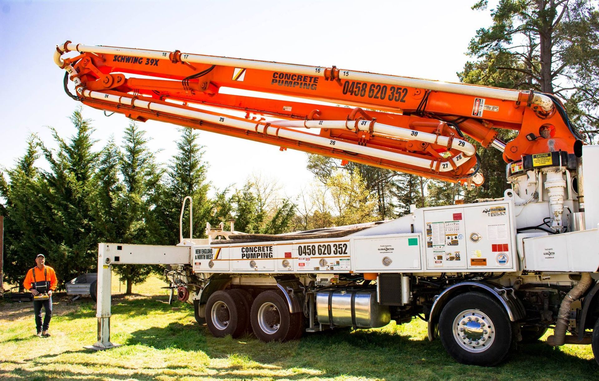 Orange and White Concrete Pump Truck — Heritage Concrete In Glen Innes, NSW