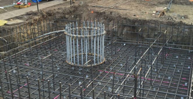 A Pile Of Steel Bars Is Sitting In The Middle Of A Construction Site — Heritage Concrete In Uralla, NSW