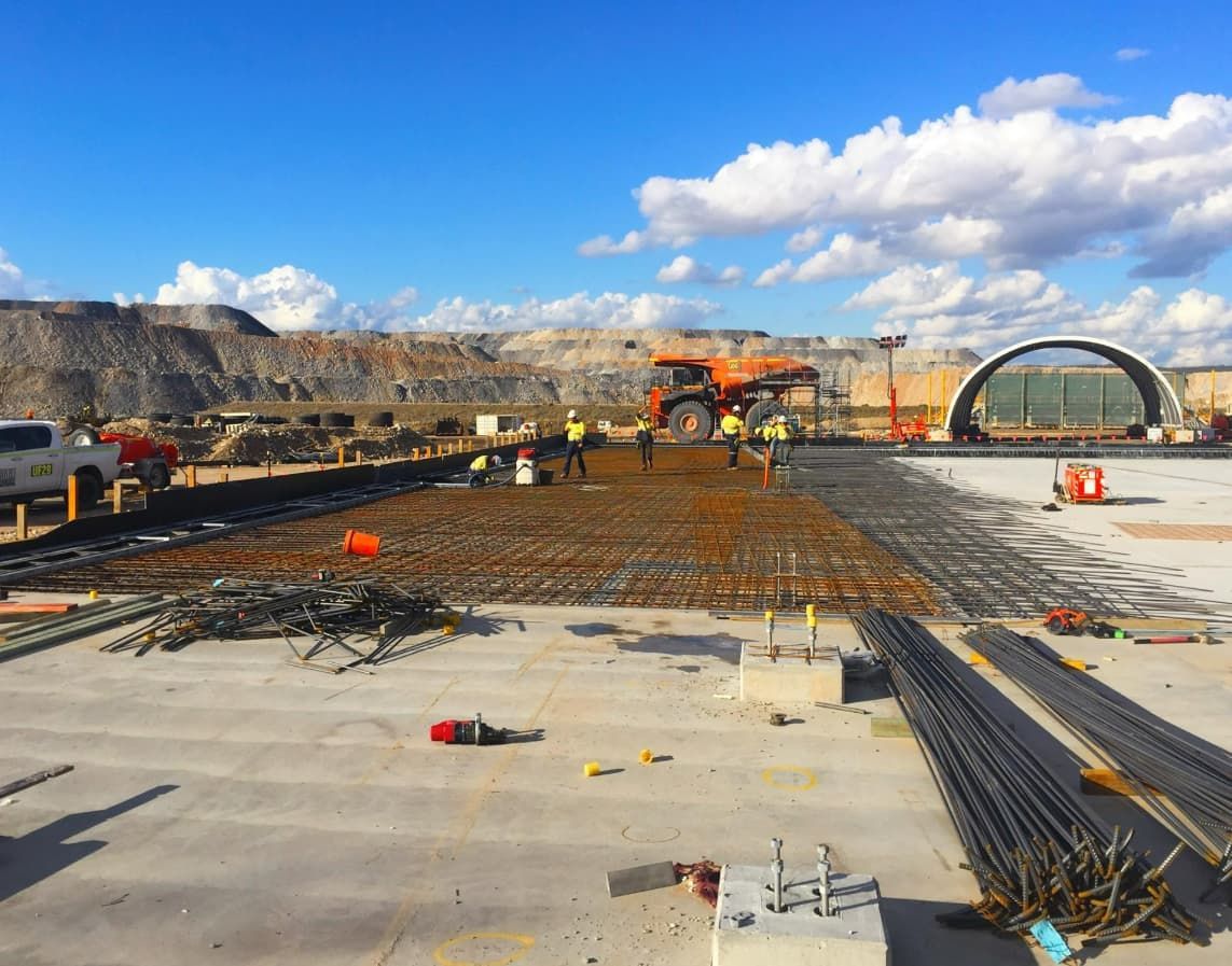 A Group Of Construction Workers Are Working On A Construction Site — Heritage Concrete In Uralla, NSW