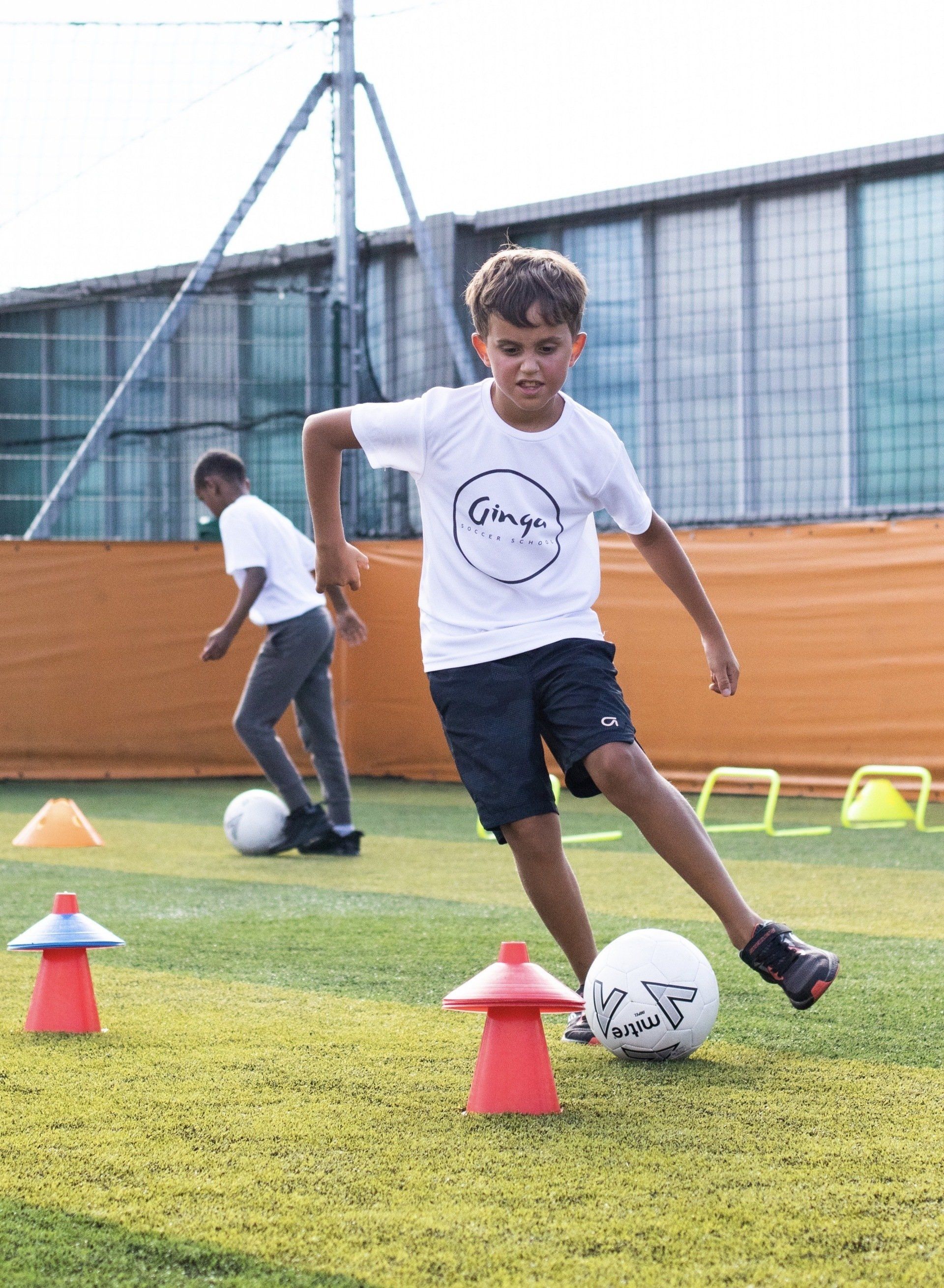 Child hitting a soccer ball