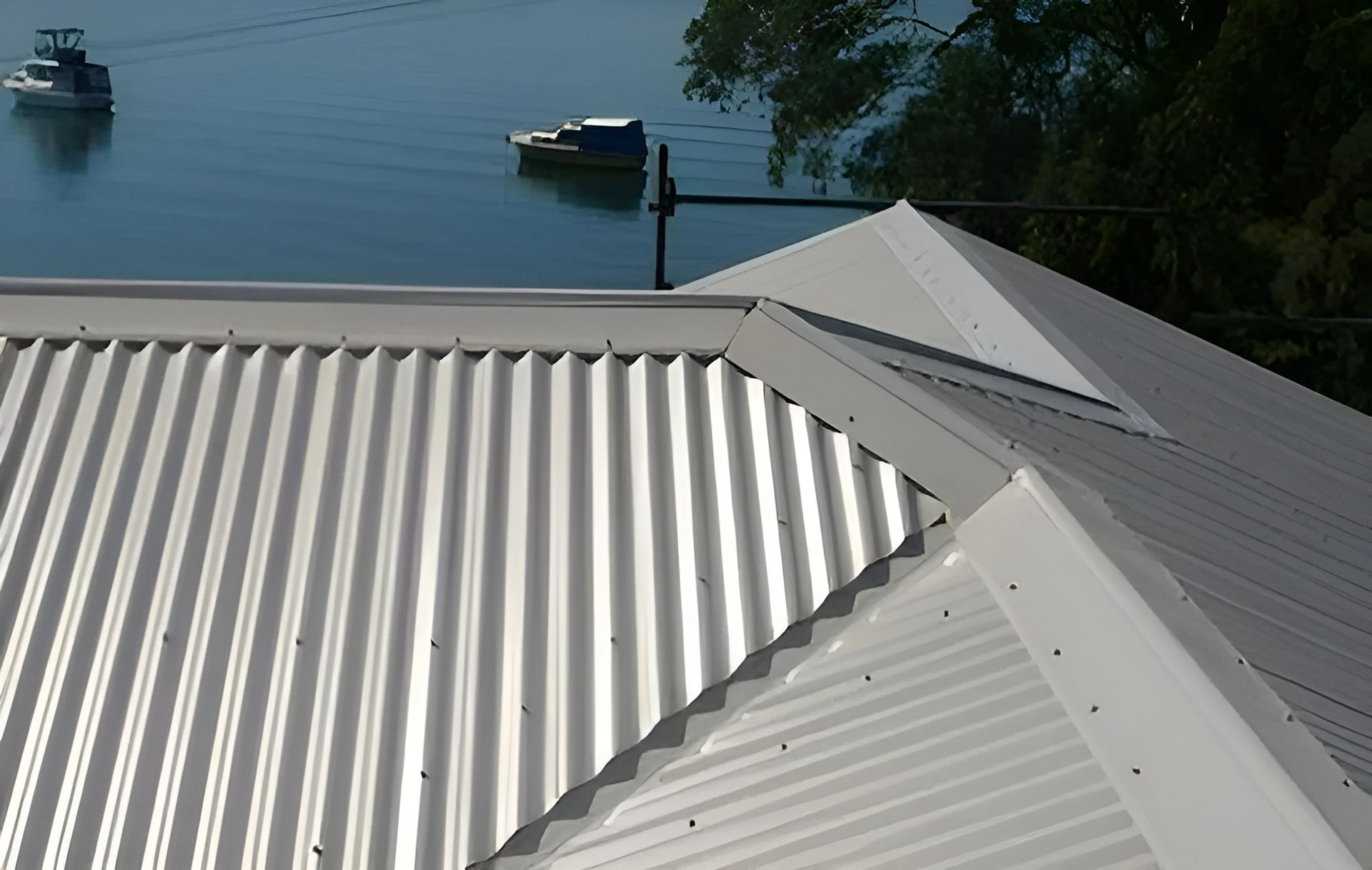 Corrugated Metal Roof with A View of Boats on The Water — Hi Tech Roofing in Kilaben Bay, NSW