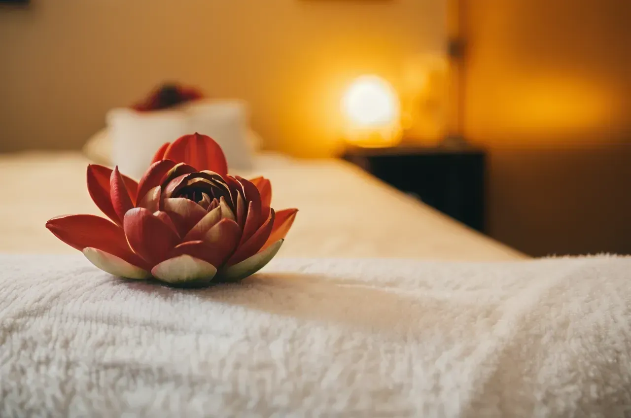 Red Lotus Flower on White Linen, Soft Lighting, Spa Setting — Traditional Massage Services In Broadbeach, QLD