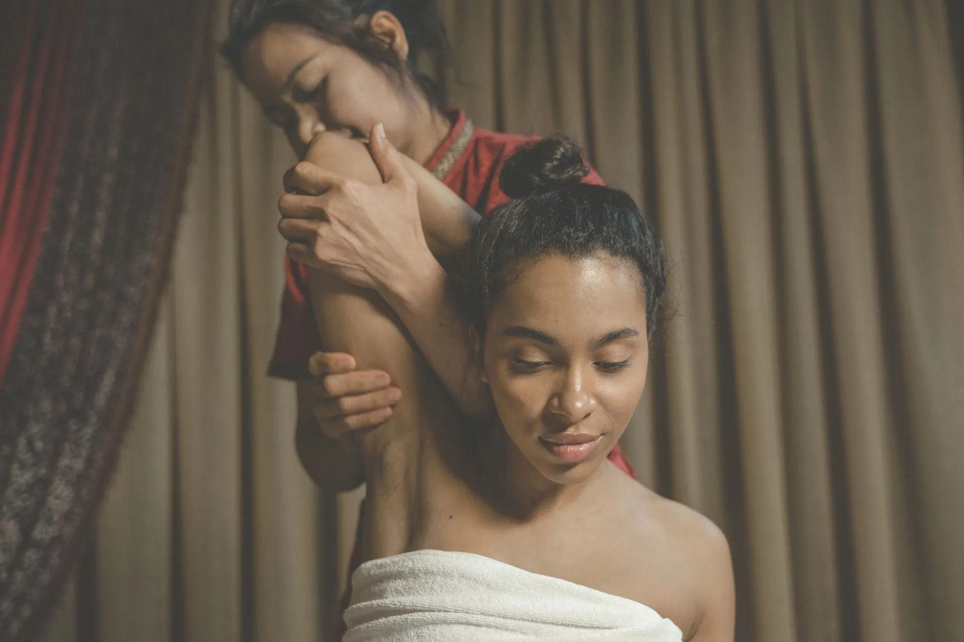 a Person Receiving an Arm Stretch During Thai Massage in a Spa Setting — Traditional Massage Services In Broadbeach, QLD