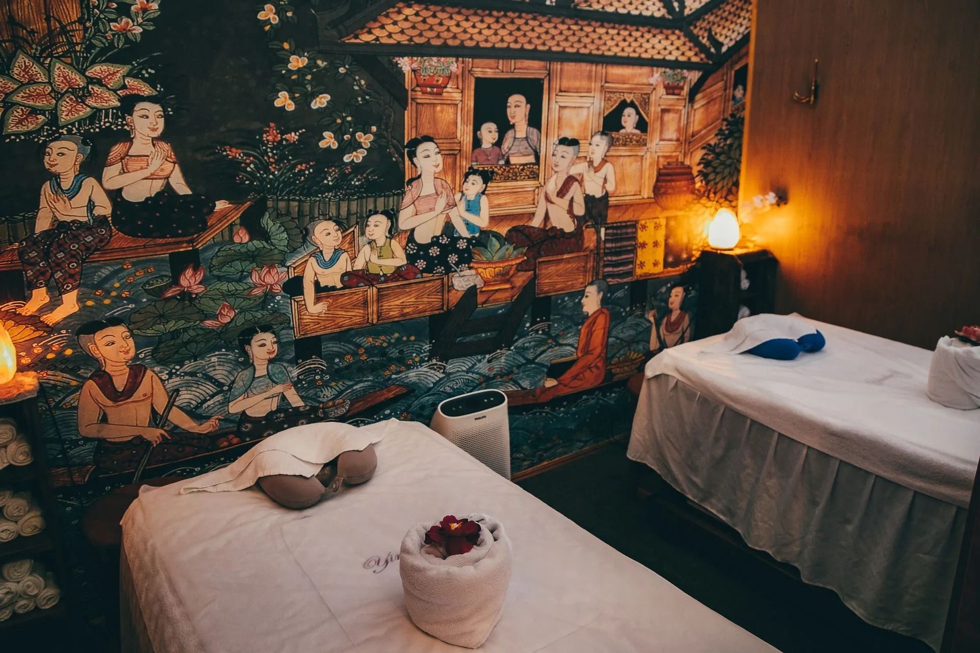 Massage Room With Two Beds, Mural of People, and Soft Lighting — Traditional Massage Services In Broadbeach, QLD
