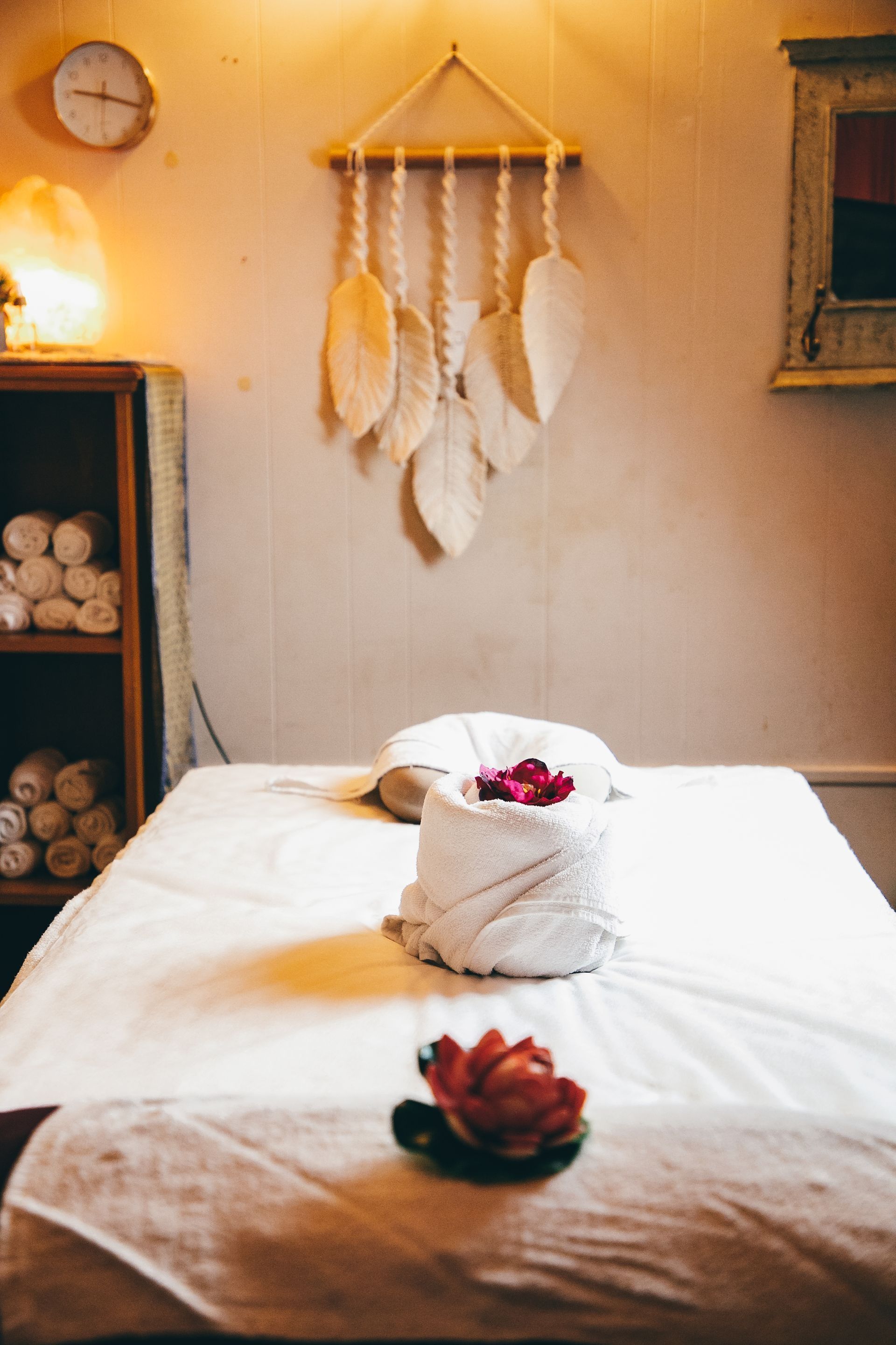 Massage Table With Towels and Flowers, Beneath a Dreamcatcher — Traditional Massage Services In Broadbeach, QLD