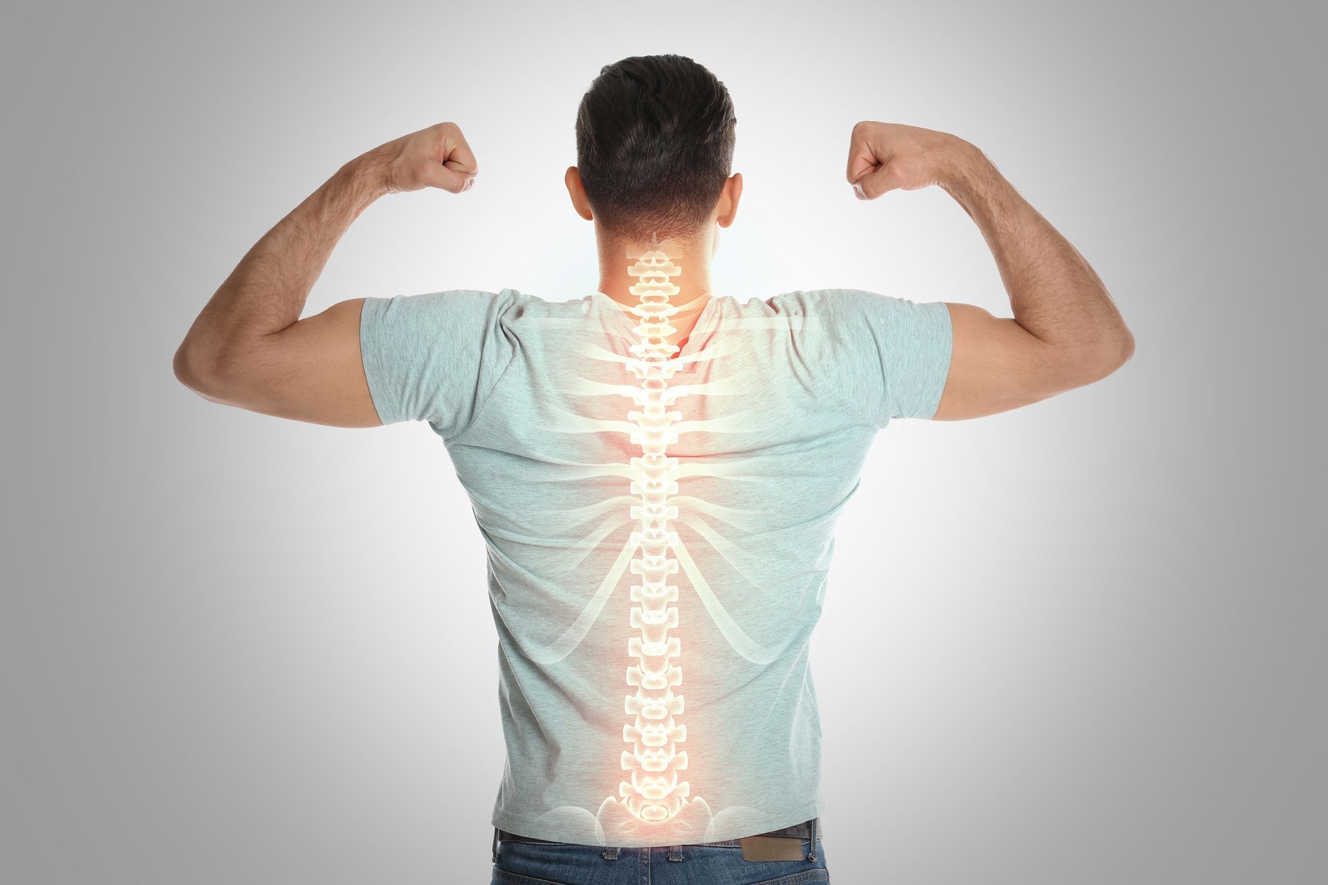 A man is flexing his muscles with a glowing spine on his back.