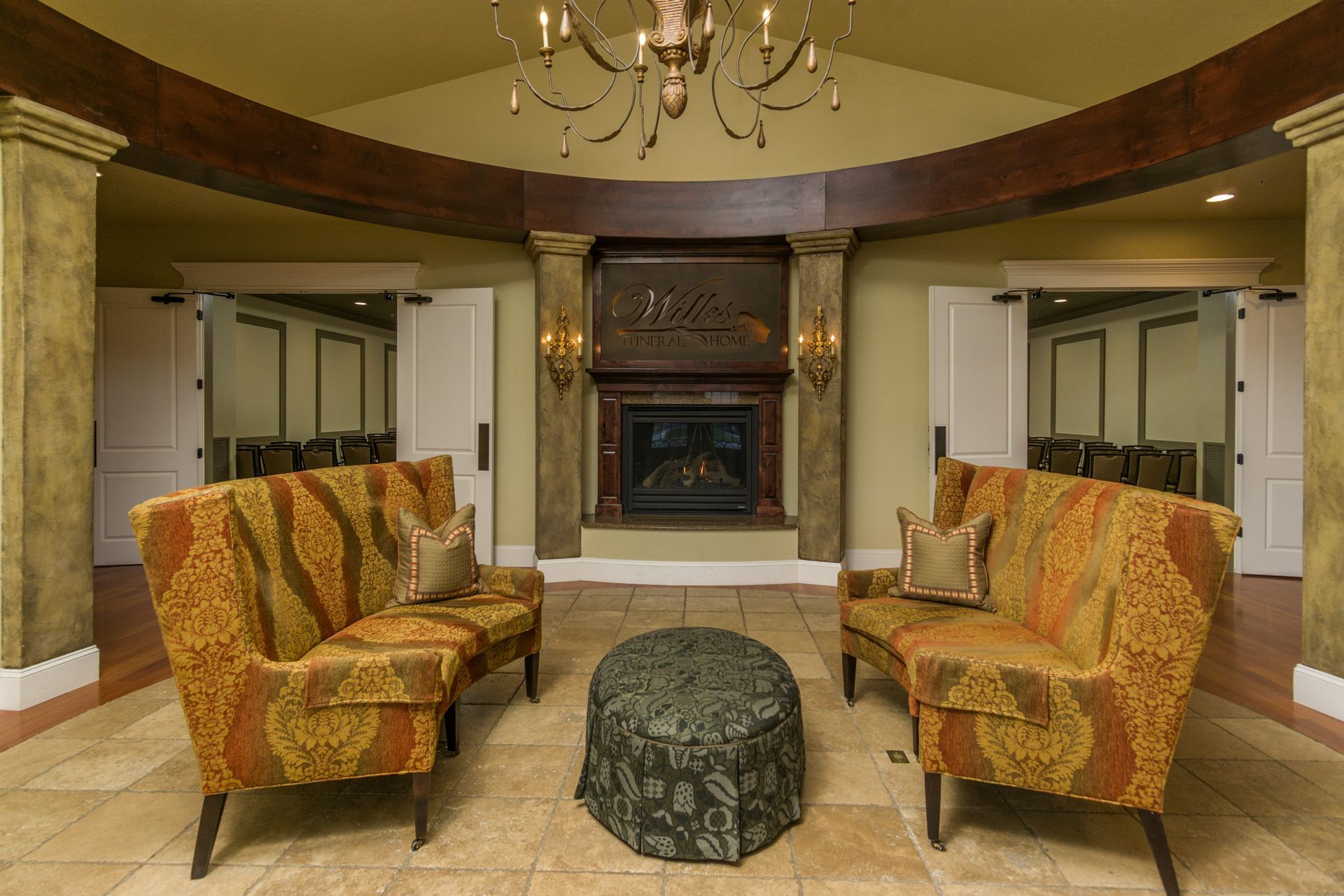 A living room with a fireplace and a chandelier