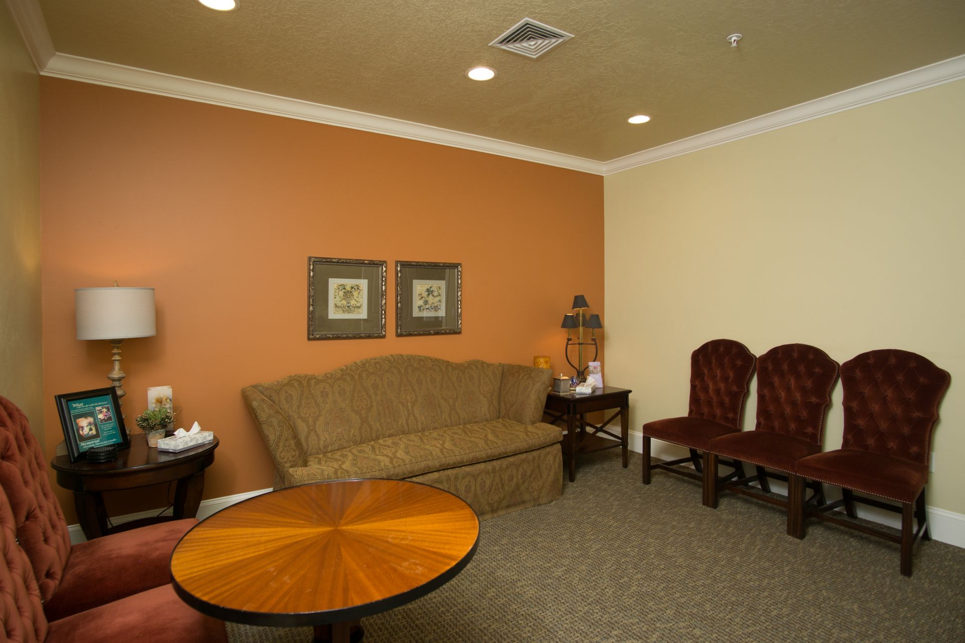 A living room with a couch , chairs and a table