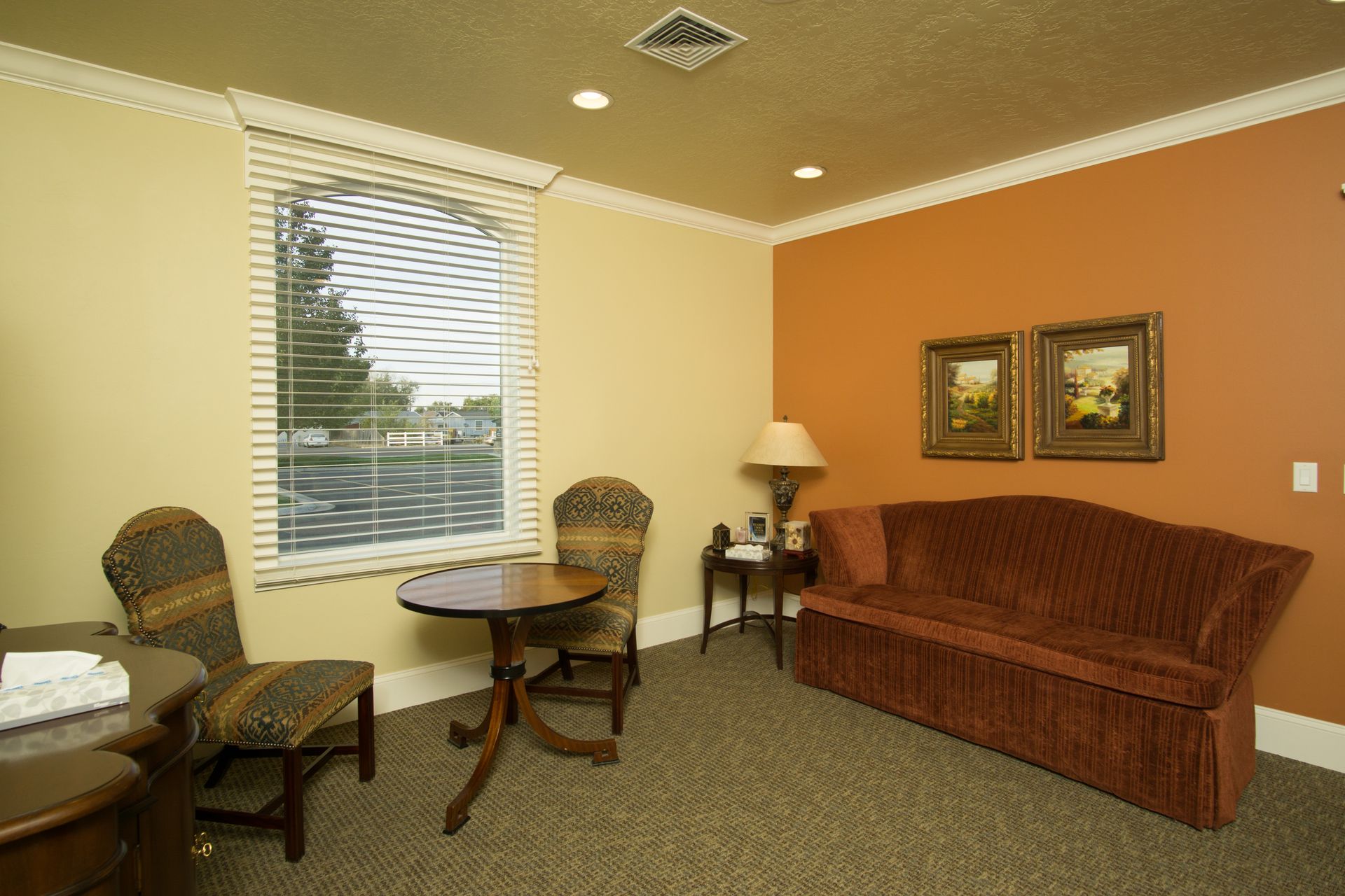 A living room with a couch a table and chairs