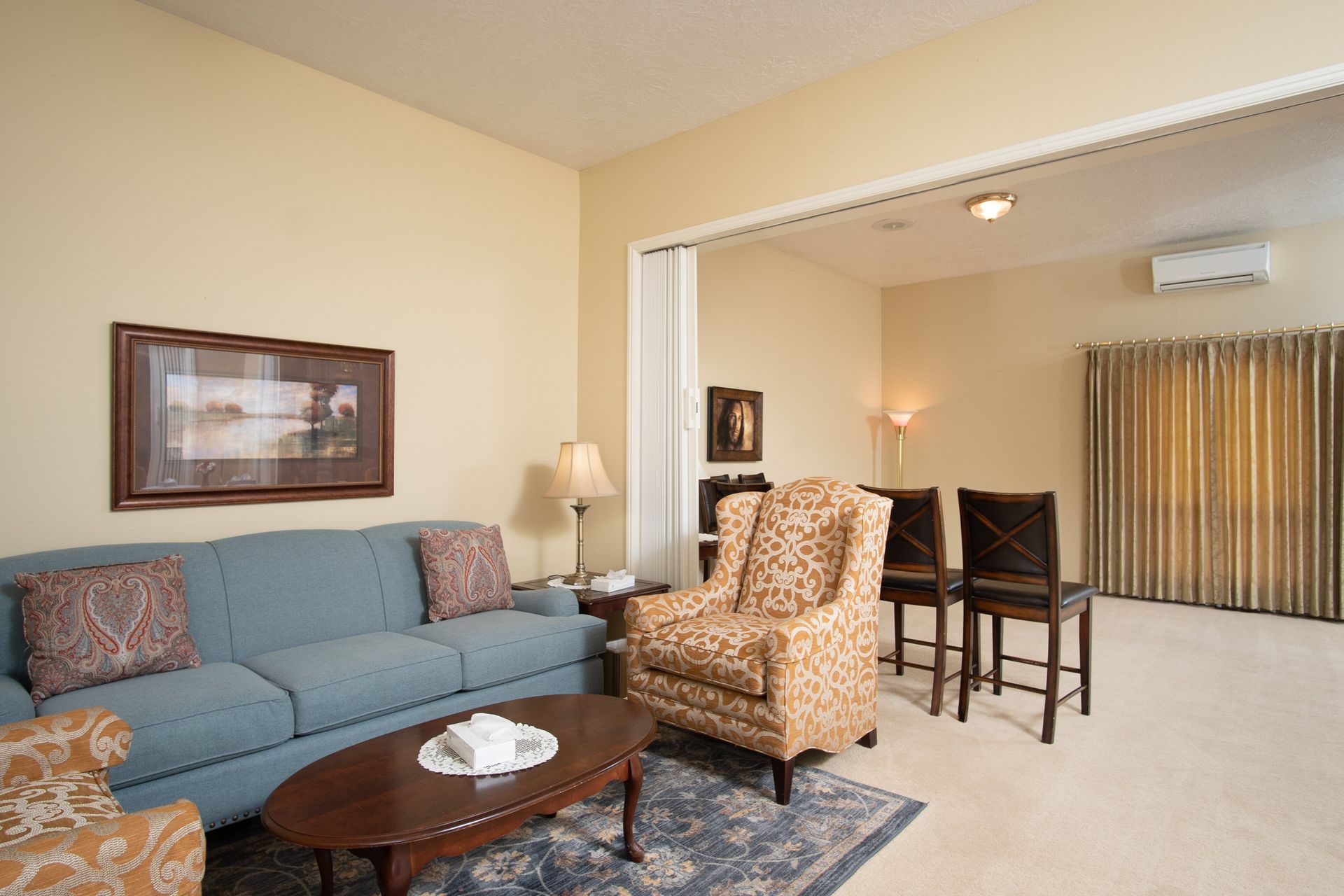 A living room with a couch , chairs and a coffee table