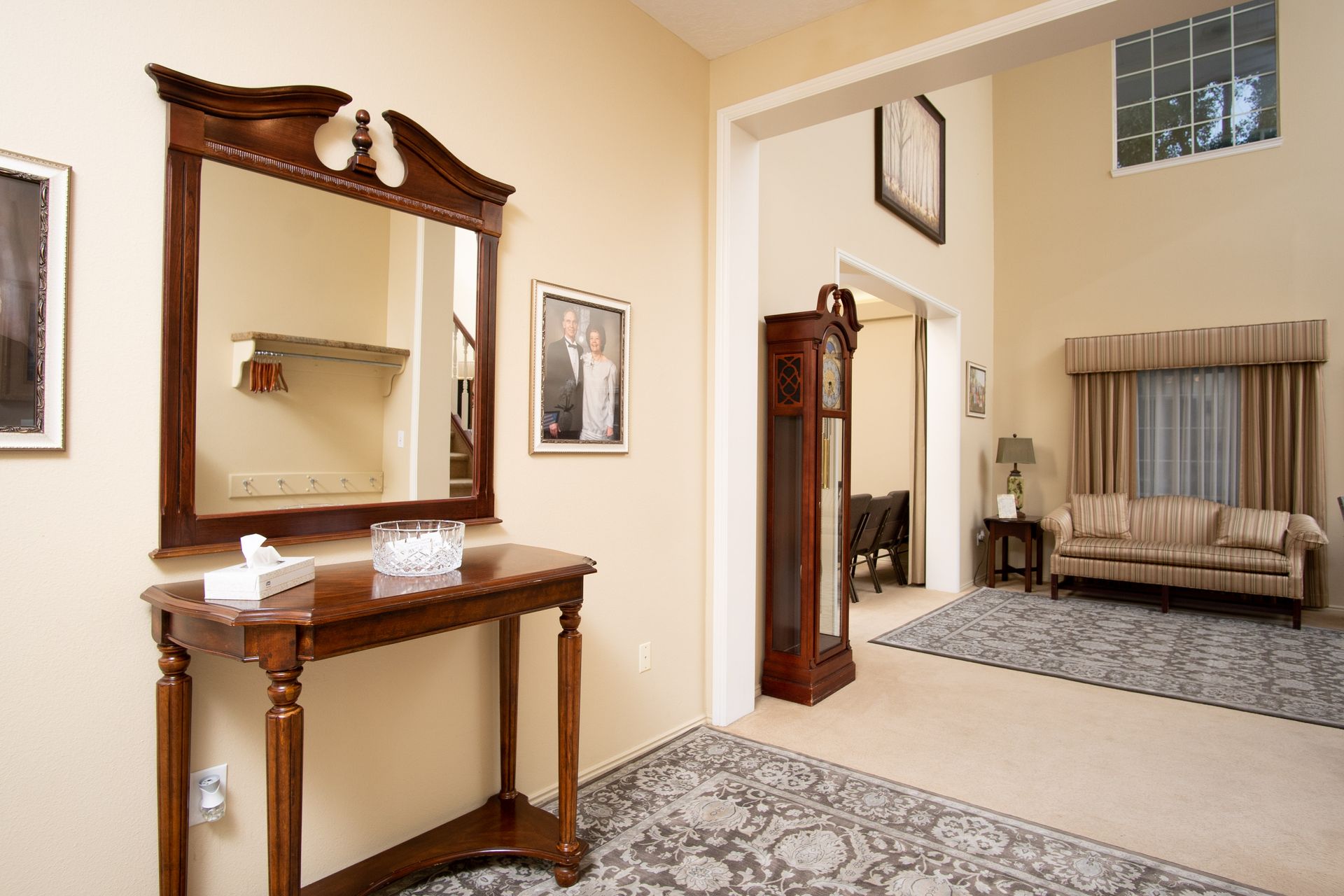 A living room with a couch and a mirror