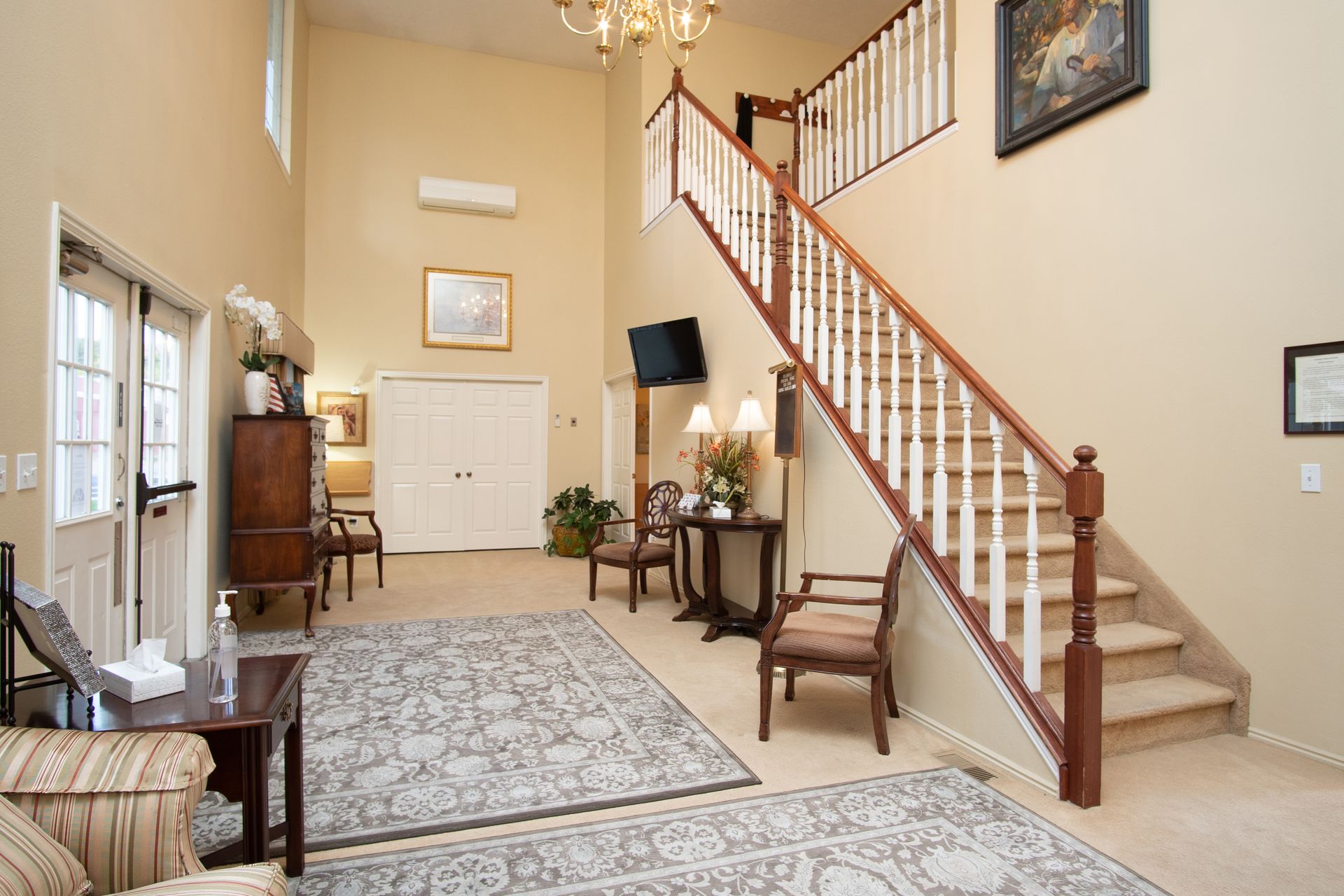 A living room with stairs leading up to the second floor