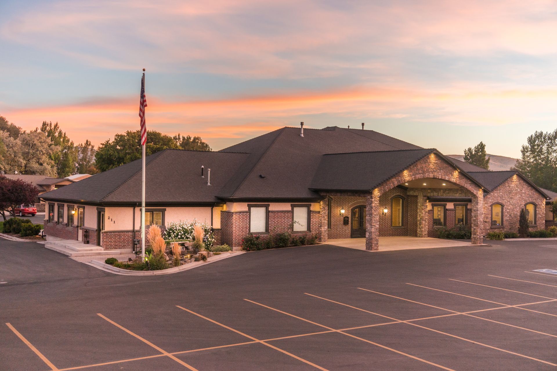 A large building with a parking lot in front of it.