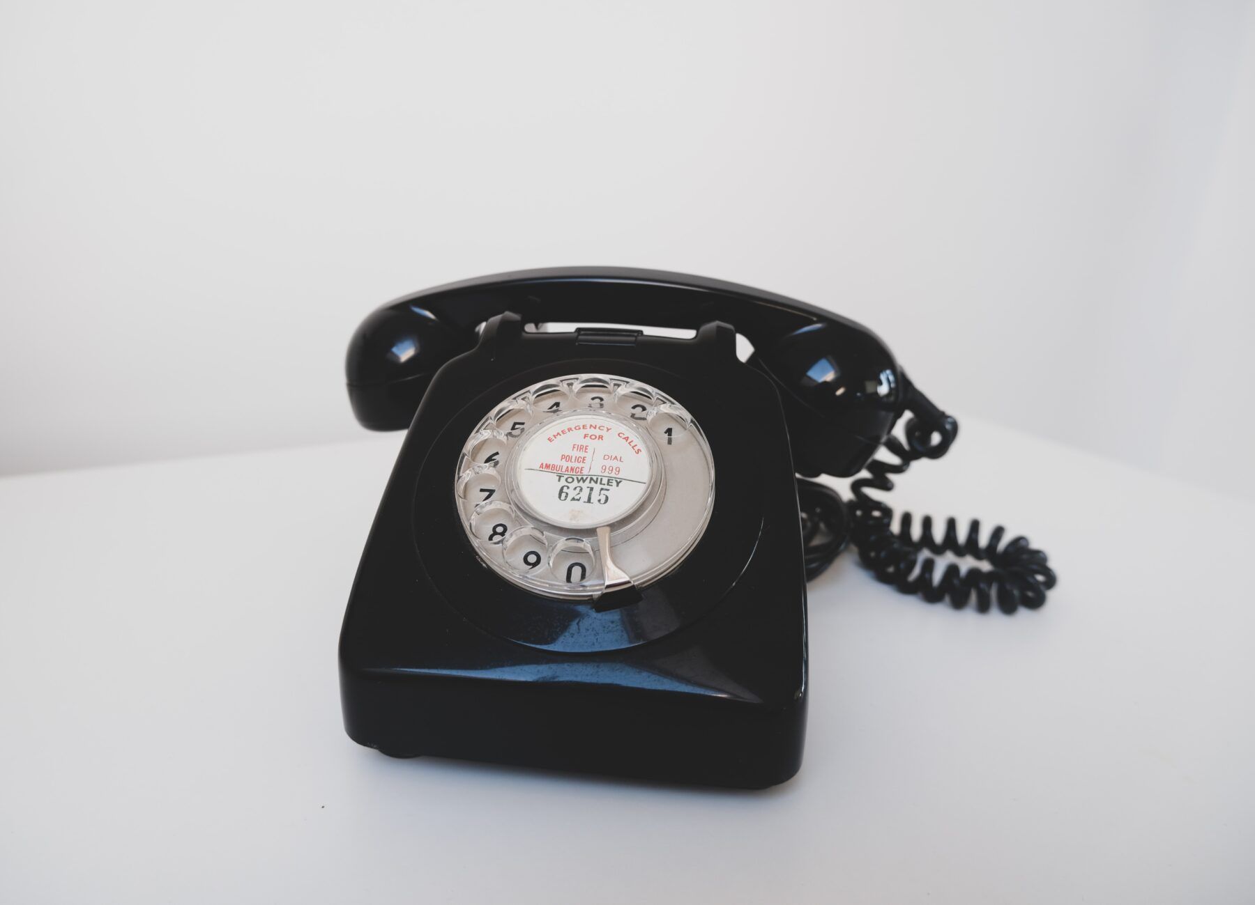 Black rotary table phone.