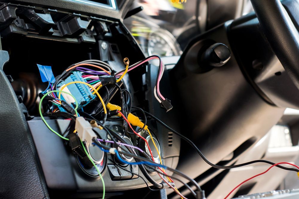A Bunch Of Wires Are Connected To A Car Dashboard — North Coast Mobile Auto Air Conditioning In Winnellie, NT