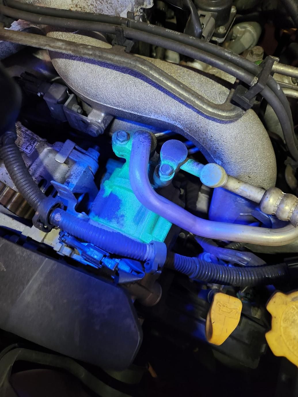 A Close Up Of A Car Engine With Blue Lights On It — North Coast Mobile Auto Air Conditioning In Winnellie, NT