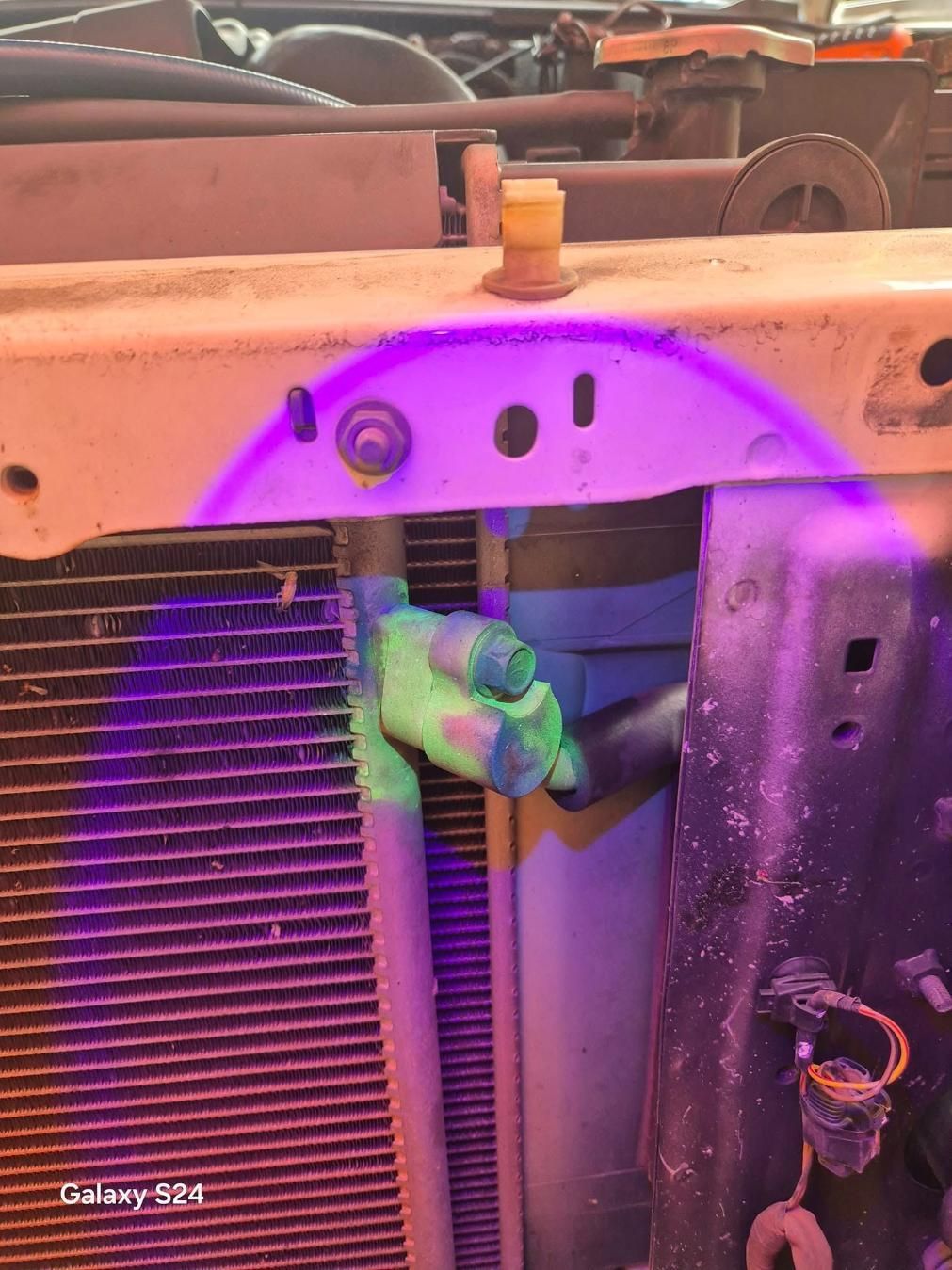 A Close Up Of A Car Radiator Under A Purple Light — North Coast Mobile Auto Air Conditioning In Winnellie, NT
