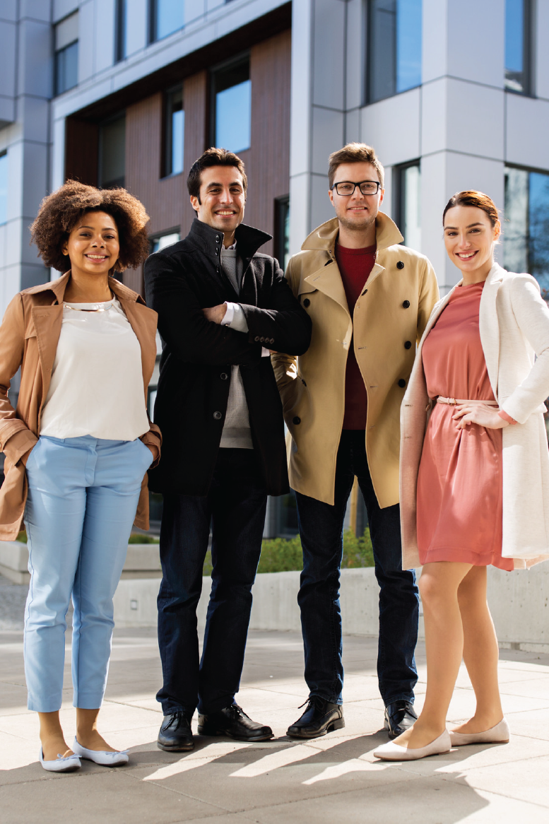 A family is sitting on the floor looking at a laptop computer.