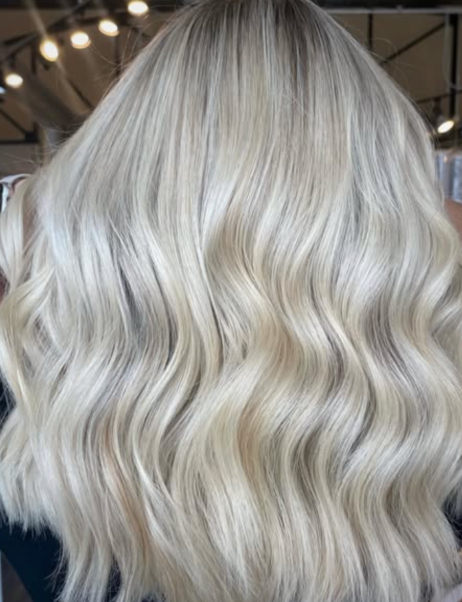 Shoulder-length, wavy hair with a platinum blonde, multi-tonal color palette.