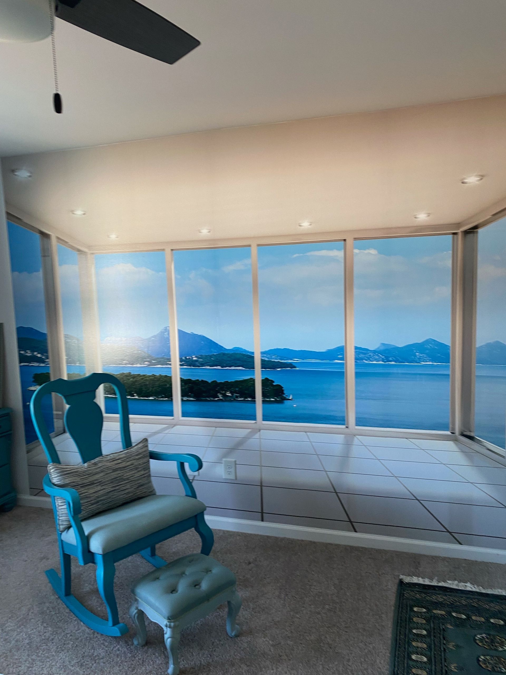 A bathroom with a large window and a ladder.