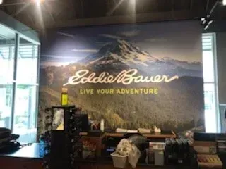 A eddie bauer sign hangs above a counter in a store