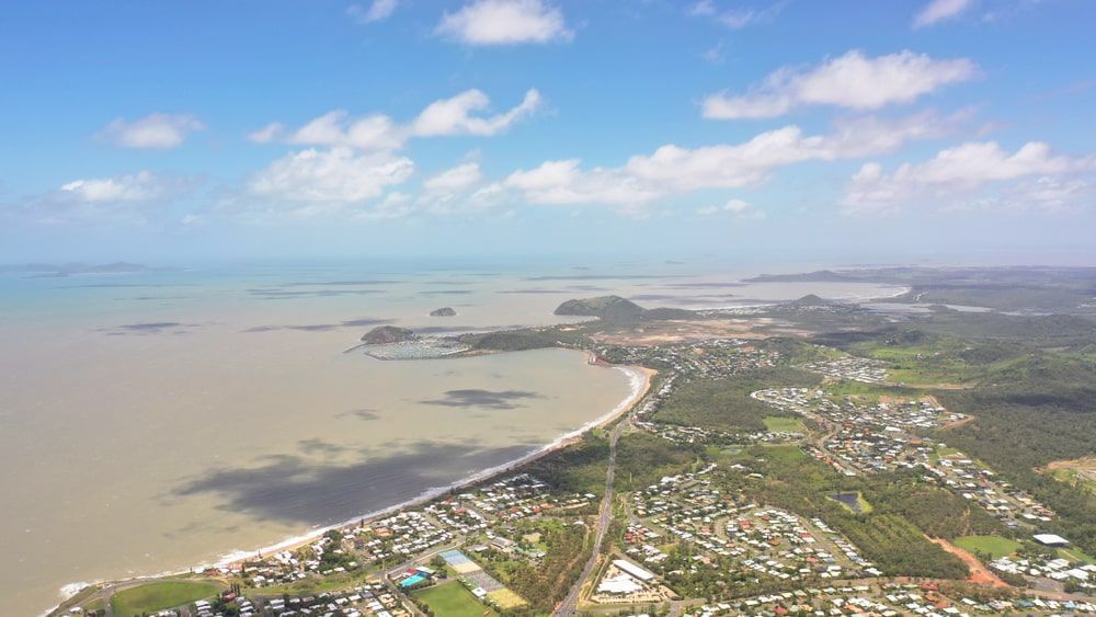 An Aerial View Of A City Next To A Body Of Water — Brown's Vegetation Management In Yeppoon, QLD