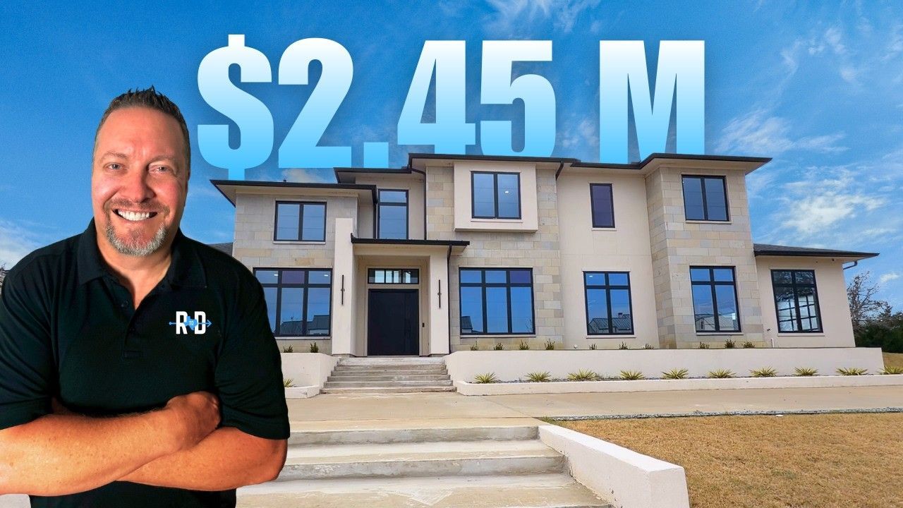 Realtor stands in front of a modern house, price $2.45M, smiling. Sunny day, blue sky.