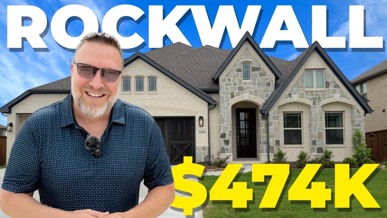 A man is standing in front of a rockwall house