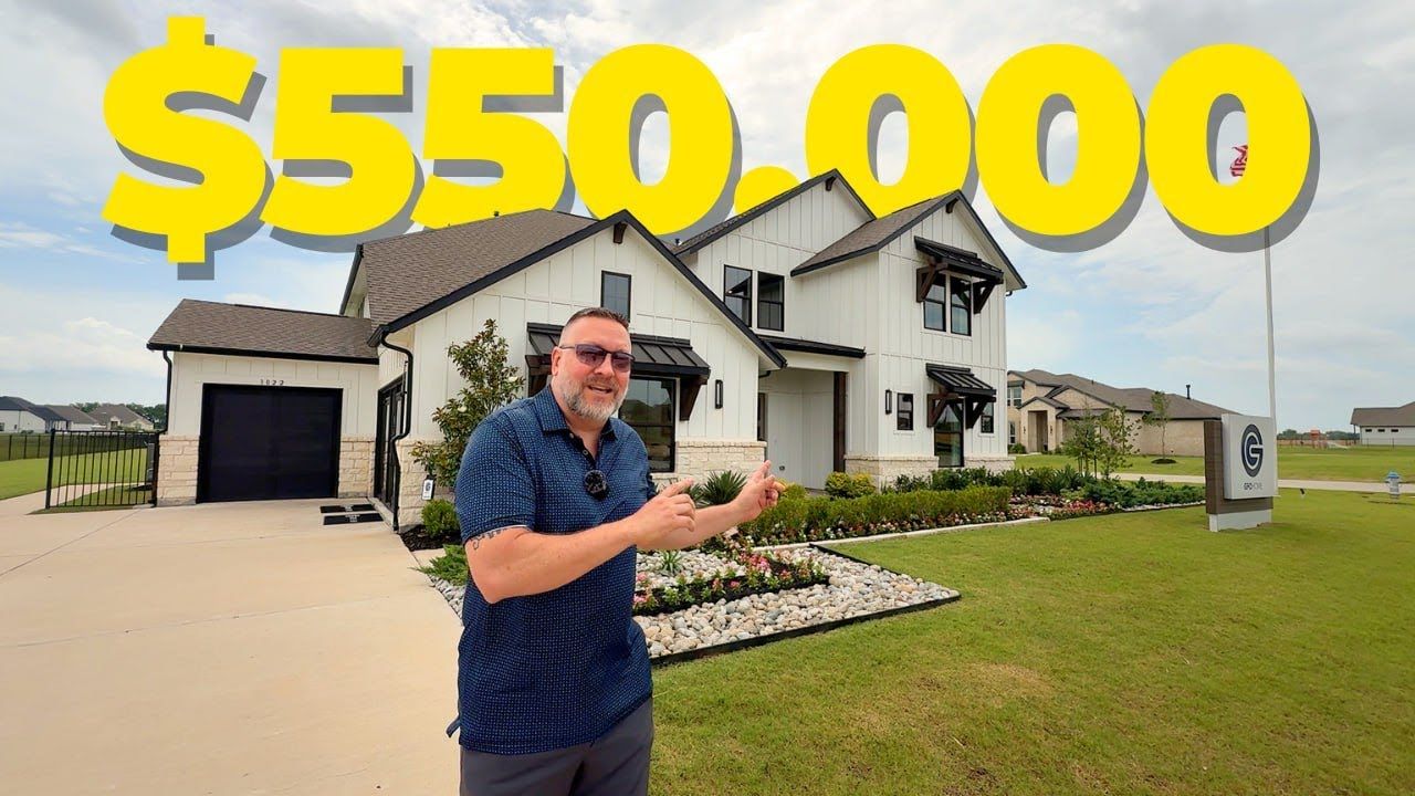 A man is standing in front of a house that is worth $ 550,000.