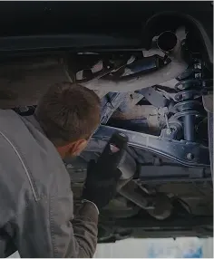 Man performing Suspension Repair with flashlight | Foltz Automotive