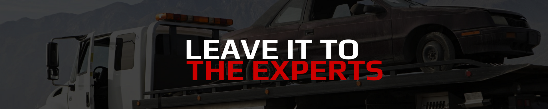 A tow truck carries a damaged car, text: 