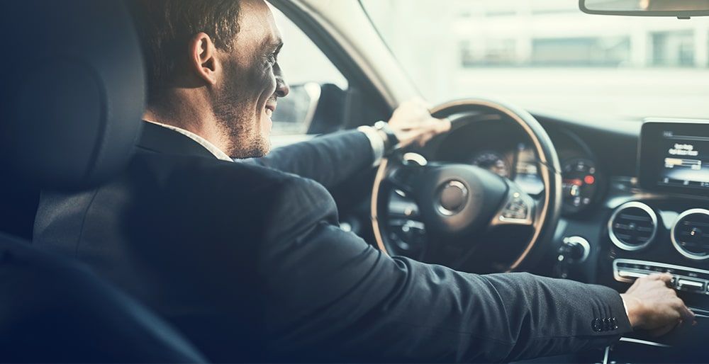 A chauffeur driving a car.