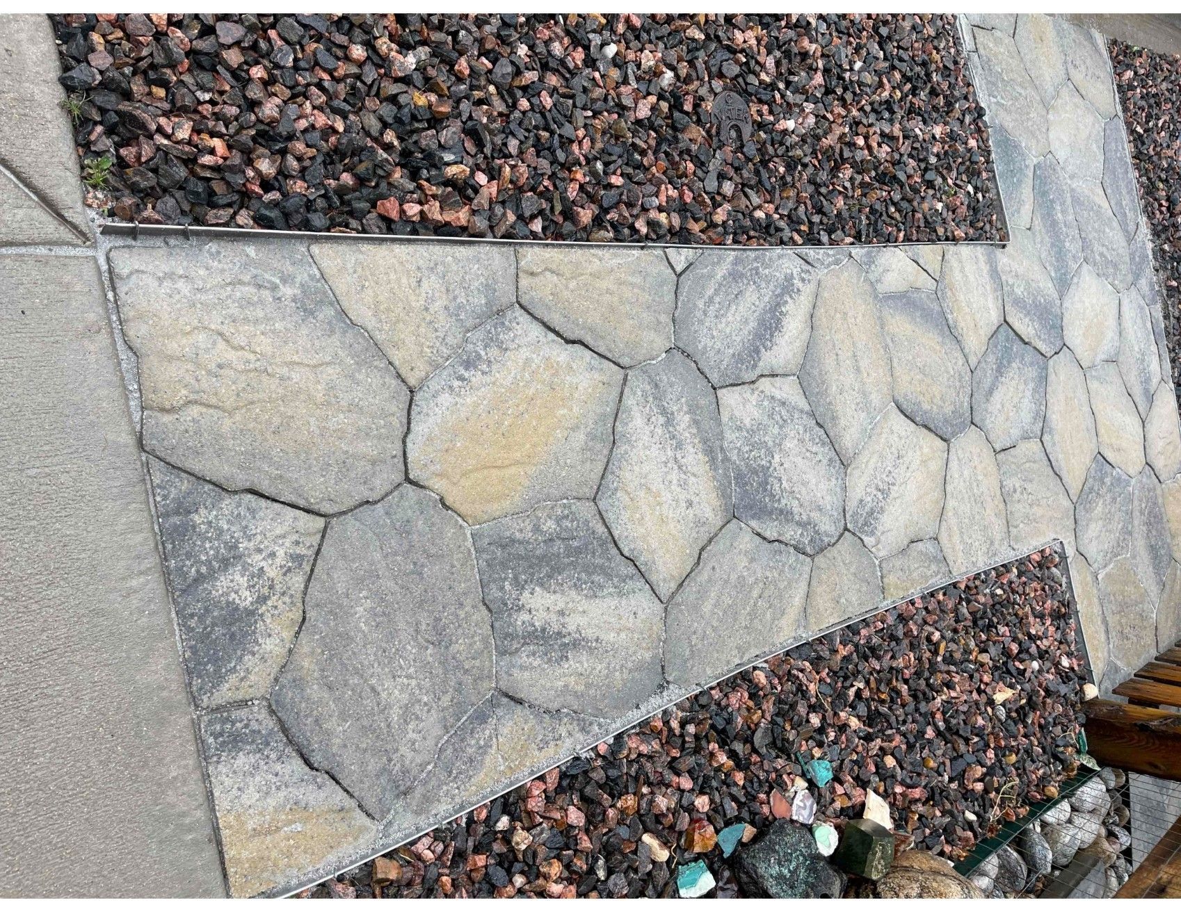 A stone walkway surrounded by gravel and rocks.