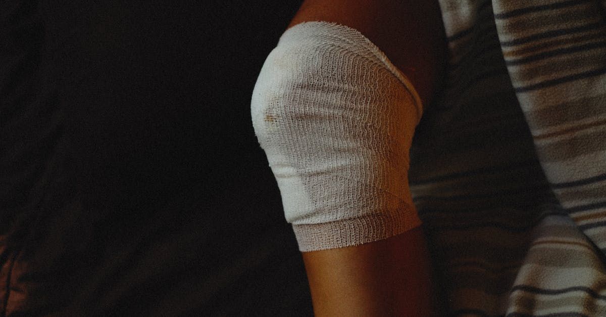 A close up of a person 's knee with a bandage on it.