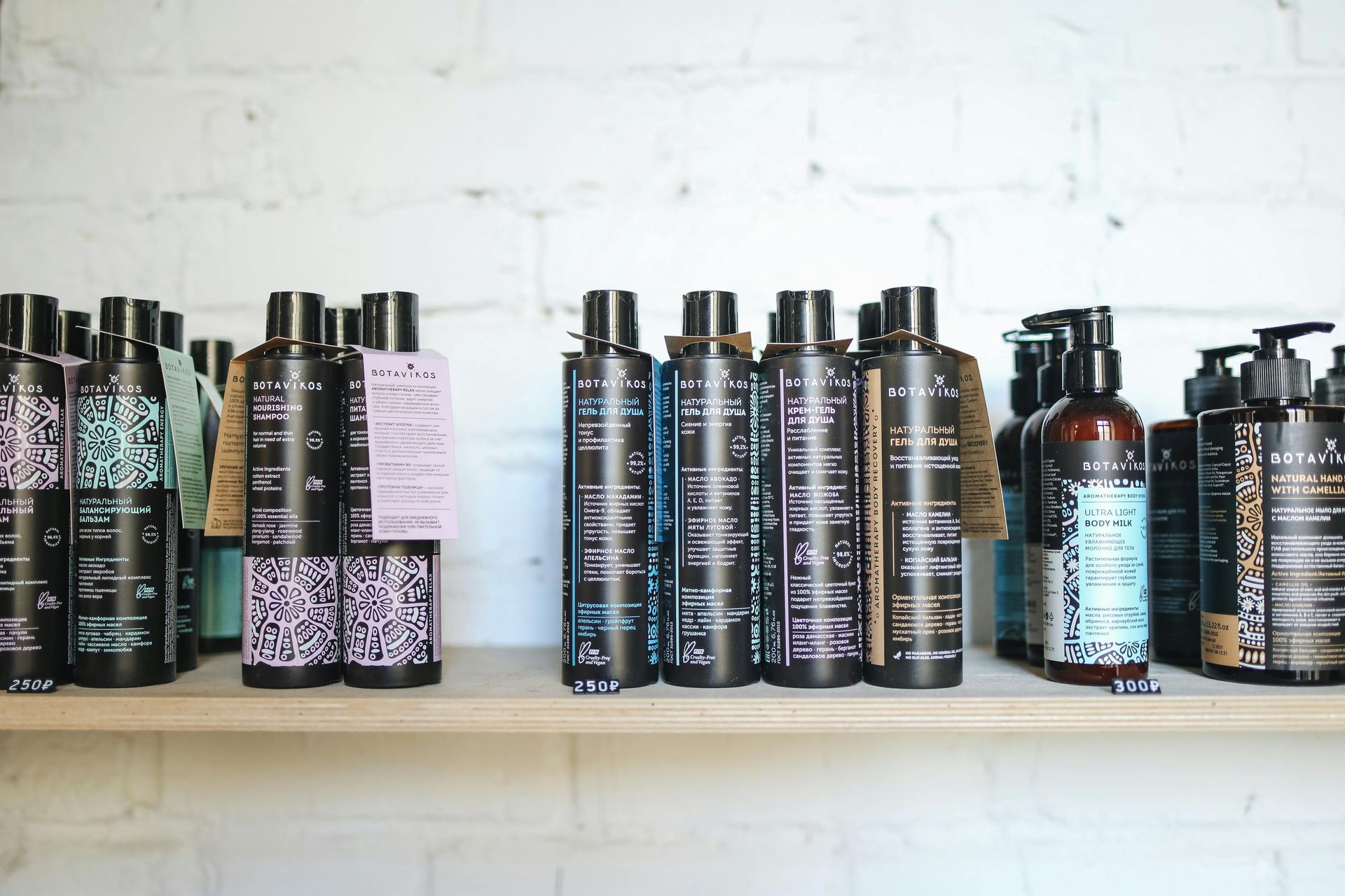 A shelf filled with bottles of shampoo and conditioner.