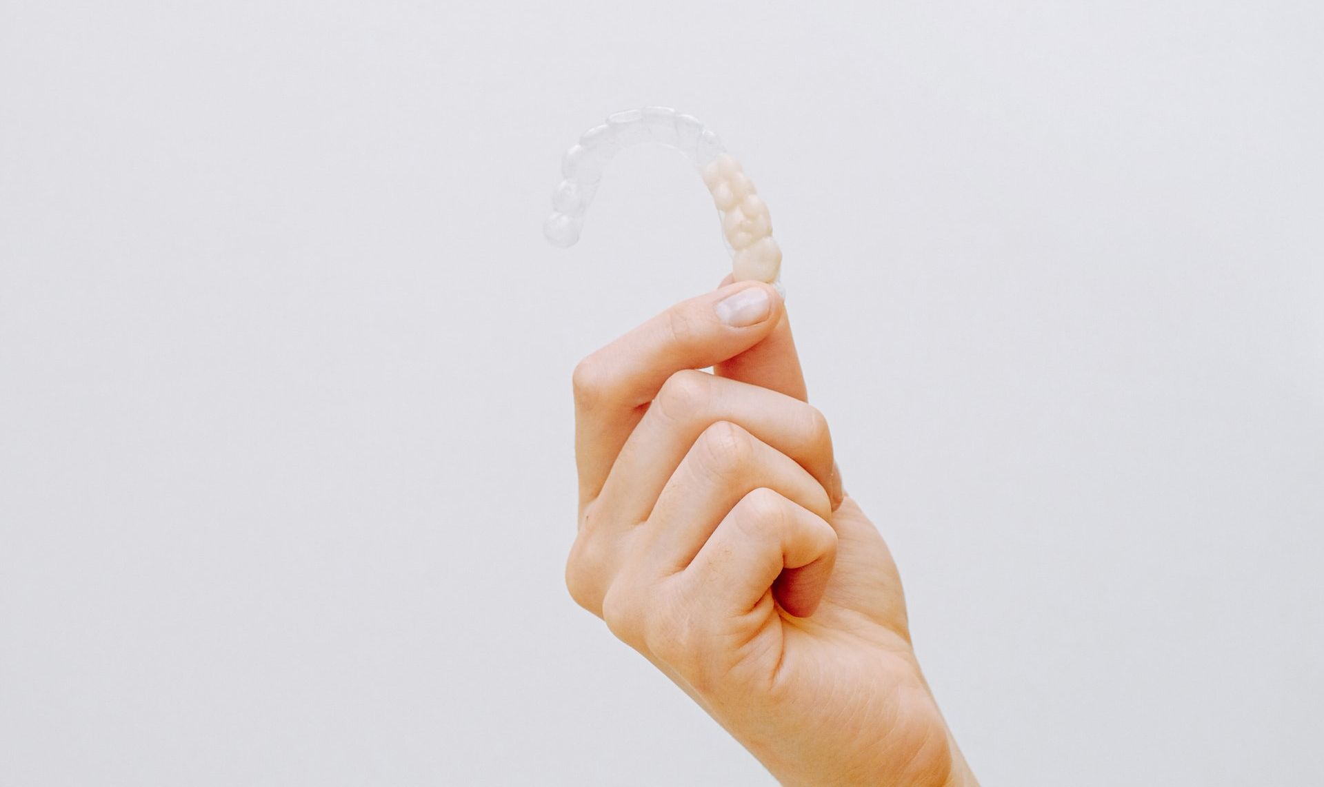 Dentist holding a dental implant