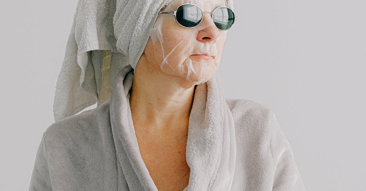 A woman with a towel wrapped around her head and a mask on her face.