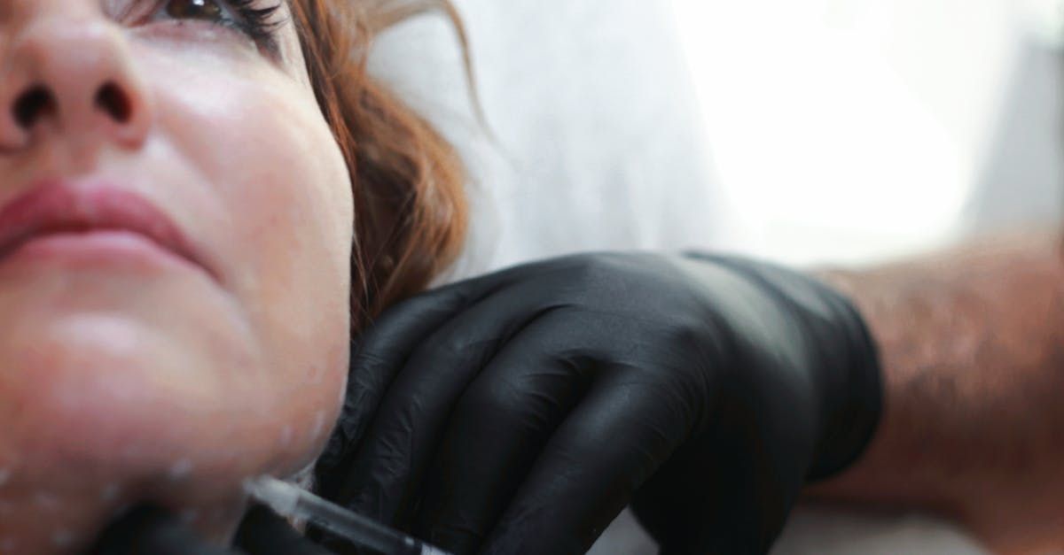 A woman is getting a botox injection in her face.