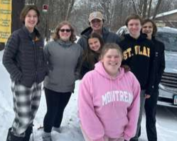 A group of young people are posing for a picture together.