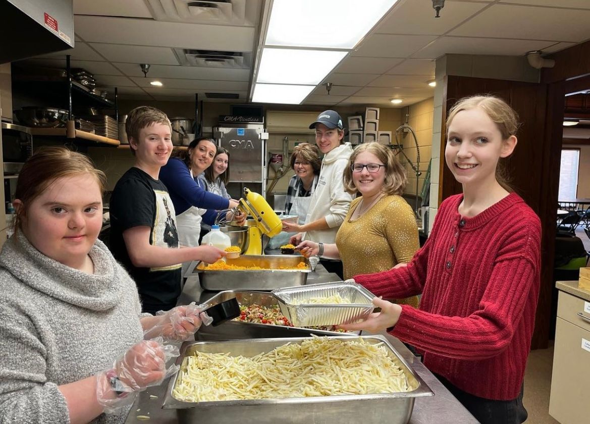 A group of people are preparing food in a kitchen.