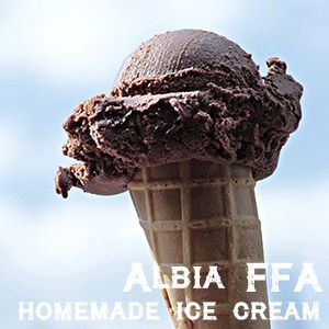 A chocolate ice cream scoop on a wafer cone against a blue sky, with the text 'Albia FFA Homemade Ice Cream.'