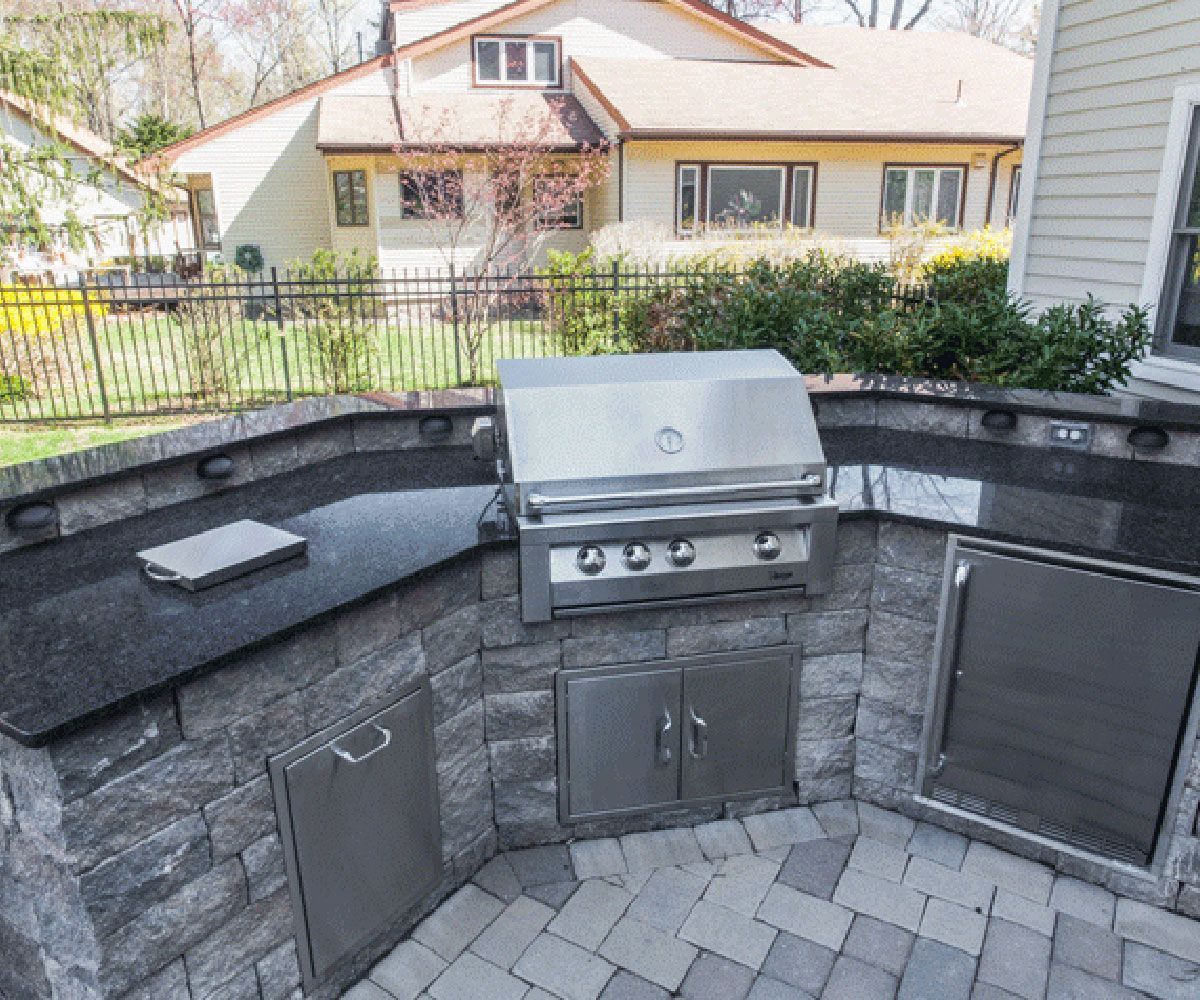 Custom leather side natural stone outdoor countertop on Copley patio outdoor kitchen