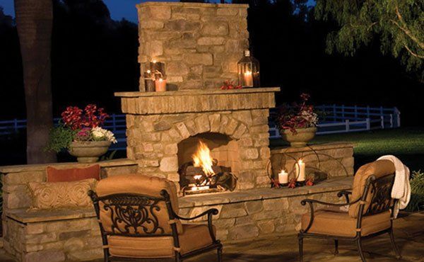 Backyard outdoor stone fireplace and pizza oven